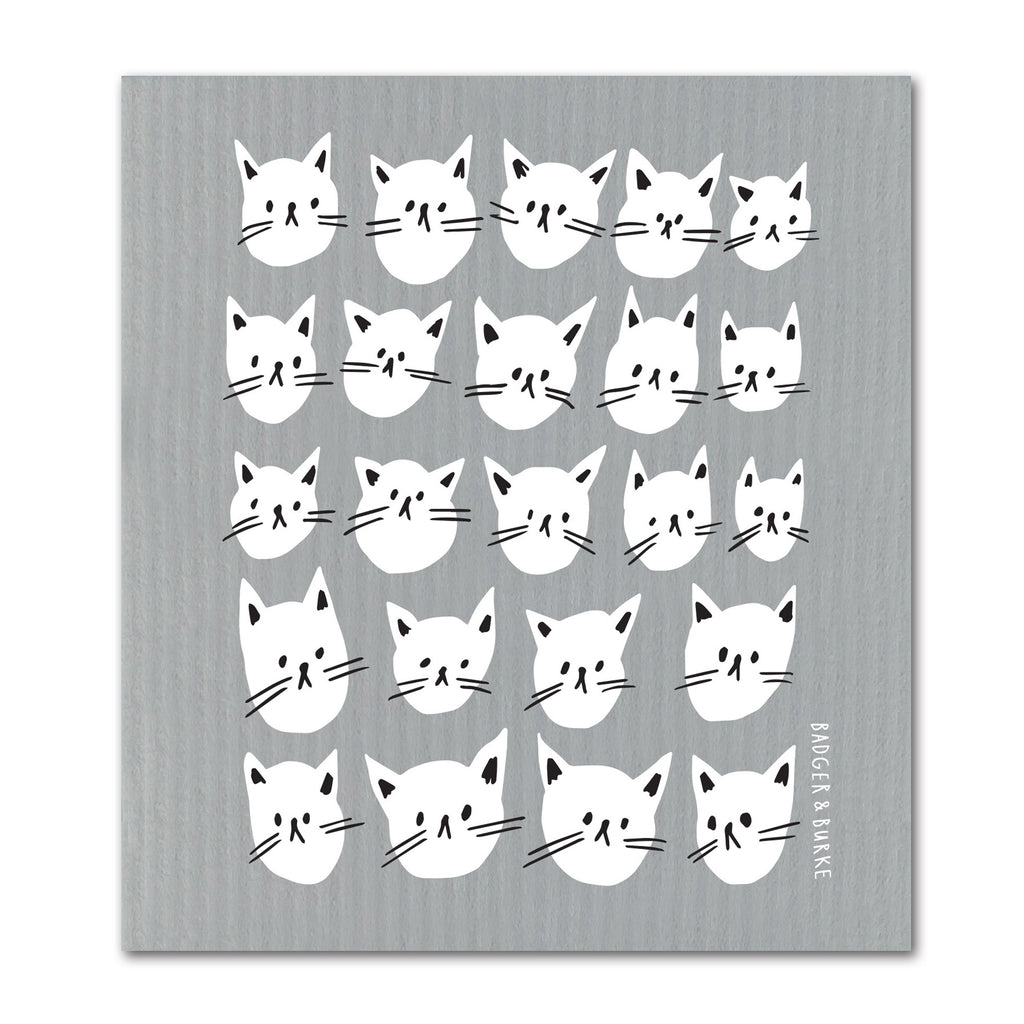 a grey swedish sponge cloth featuring an illustration of numerous white cat faces in rows and colums