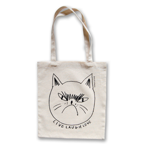 a tote bag with a black line drawing of an angry, grumpy cat with the text "live laugh love" underneath