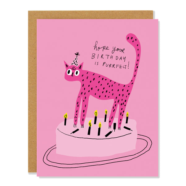 a birthday card featuring an illustration of a pink cat wearing a party hat standing on a light pink birthday cake, having knocked out a number of birthday candles. text reads: hope your birthday is purrfect"