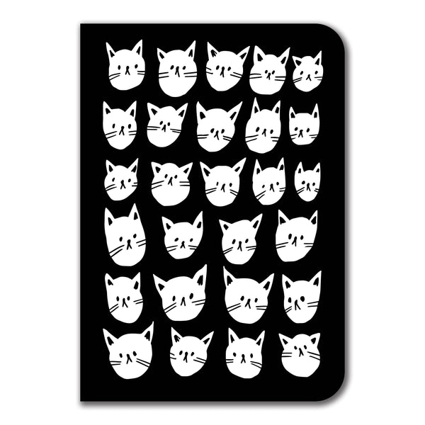 a black notebook featuring illustrations of a multitude of white cat faces in rows and columns