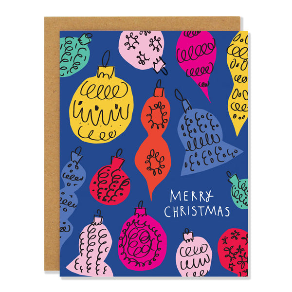 A Christmas greeting card featuring illustrations of retro 1950s Christmas baubles in multi colors against a blue background. Each bauble is a cut out shape with messy black lines over top. Text reads: Merry Christmas
