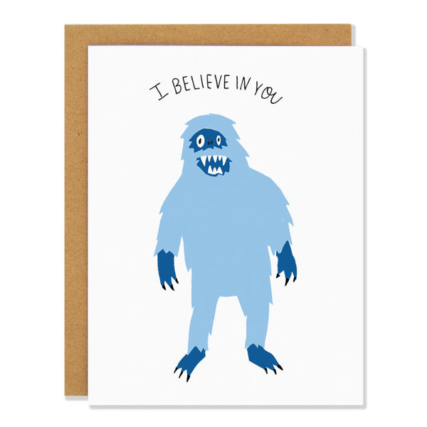 An encouraging greeting card featuring an illustration of a light blue mythical yeti figure. Text above reads: "I Believe In You" 