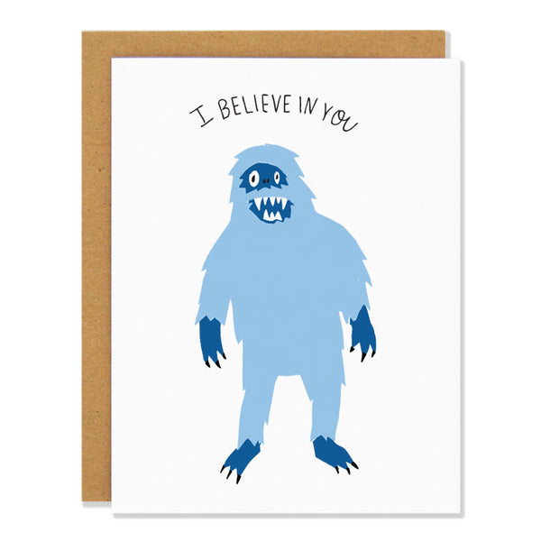 An encouraging greeting card featuring an illustration of a light blue mythical yeti figure. Text above reads: "I Believe In You"