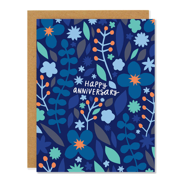 an anniversary greeting card featuring an illustration of cut out floral designs in shades of blue and orange with text reading "happy anniversary"
