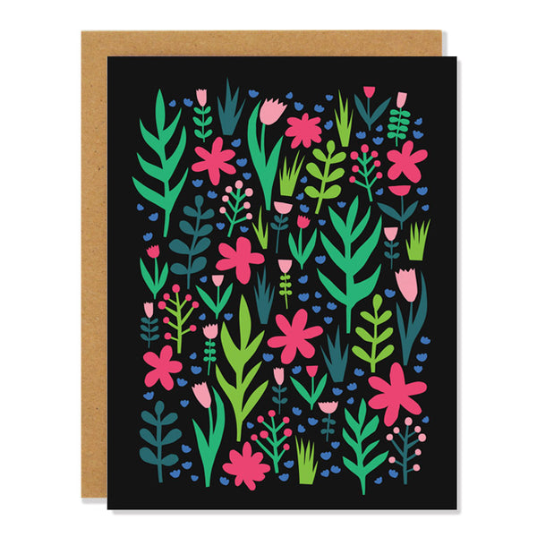 a note card with abstract cut out florals and leaves in pinks, reds, and different shades of green, on a black background