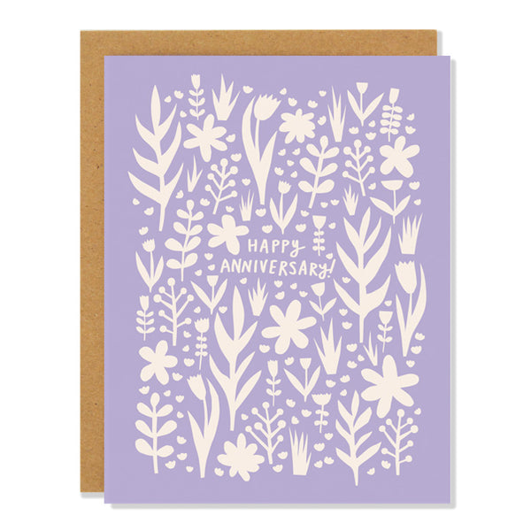 an anniversary greeting card featuring a floral cut out design and text that reads: Happy Anniversary!