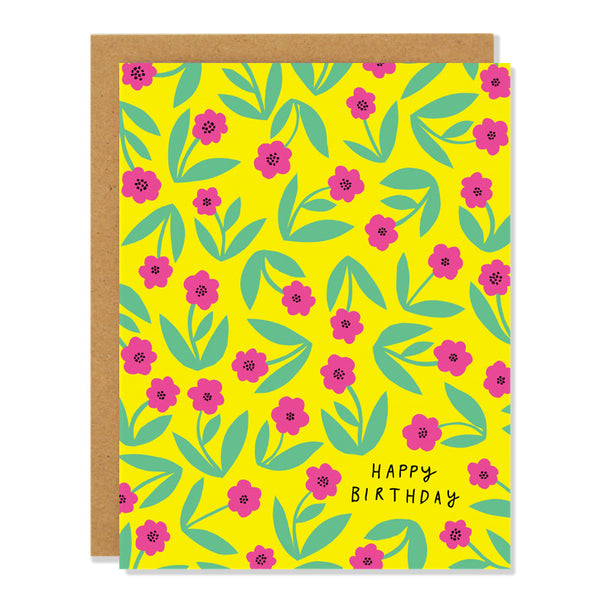 A birthday greeting card featuring a pattern of little pink flowers with green stems on a bright yellow background, with text reading "Happy Birthday".