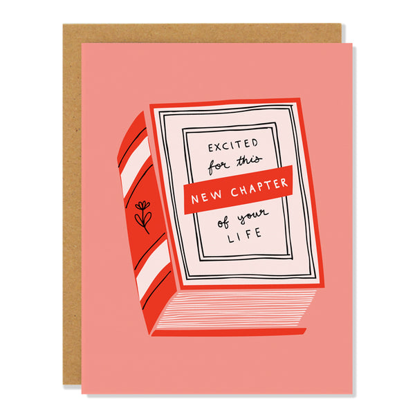 a congratulations greeting card featuring an illustration of a red bound book on a coral background, with text reading: "excited for this new chapter of your life"