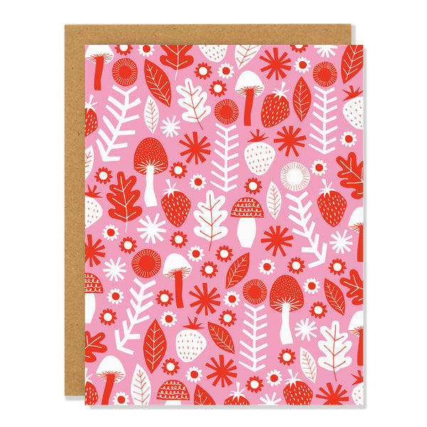 a blank note card featuring an all over pattern in red and white featuring illustrations of mushrooms, berries, and leaves on a light pink background.