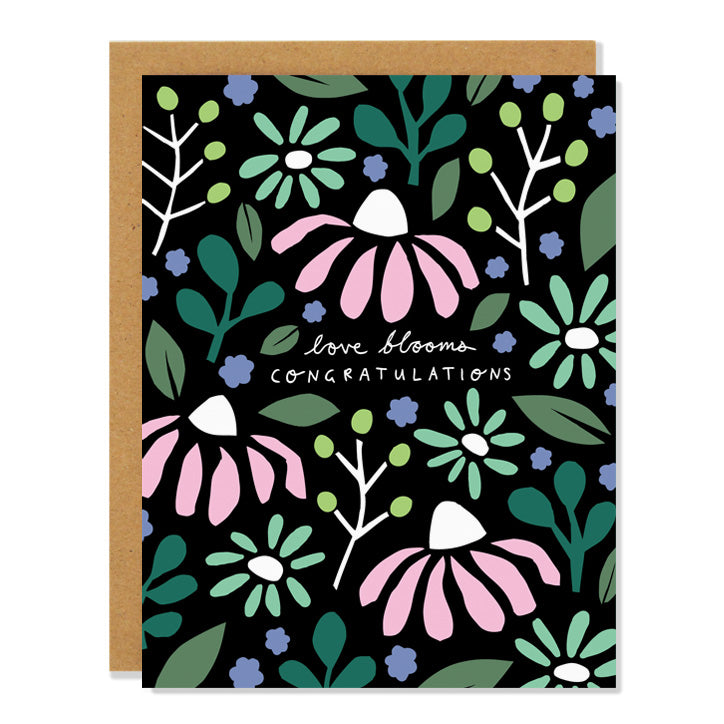 a wedding greeting card featuring floral cut out illustrations in shades of green and pink with a black background with text that reads: "love blooms, congratulations"