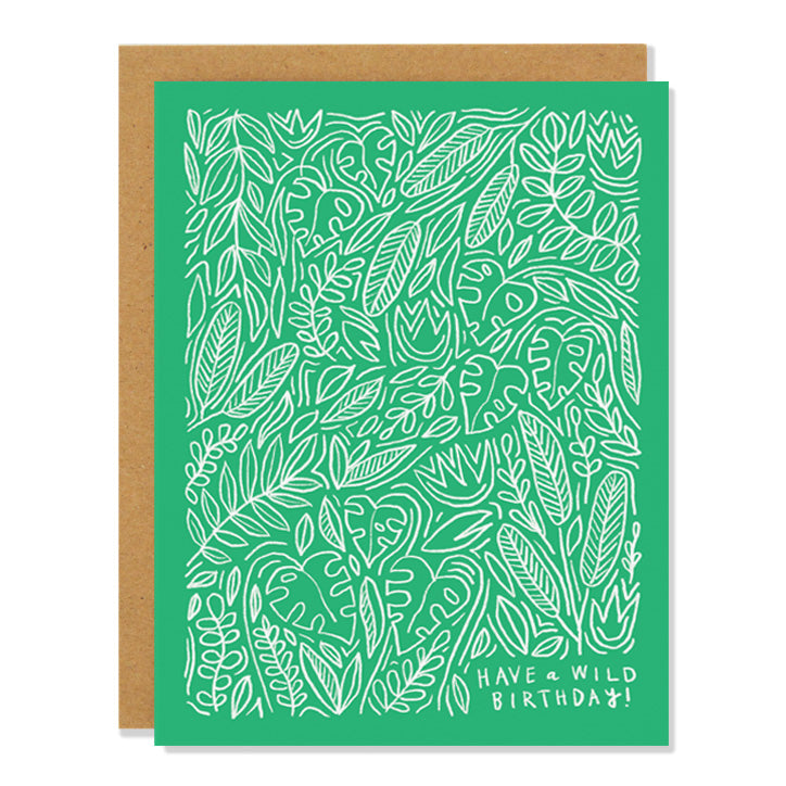 a birthday greeting card featuring a white line drawing of tropical flora including monsteras on a green background. The text on the bottom reads "Have a Wild Birthday"