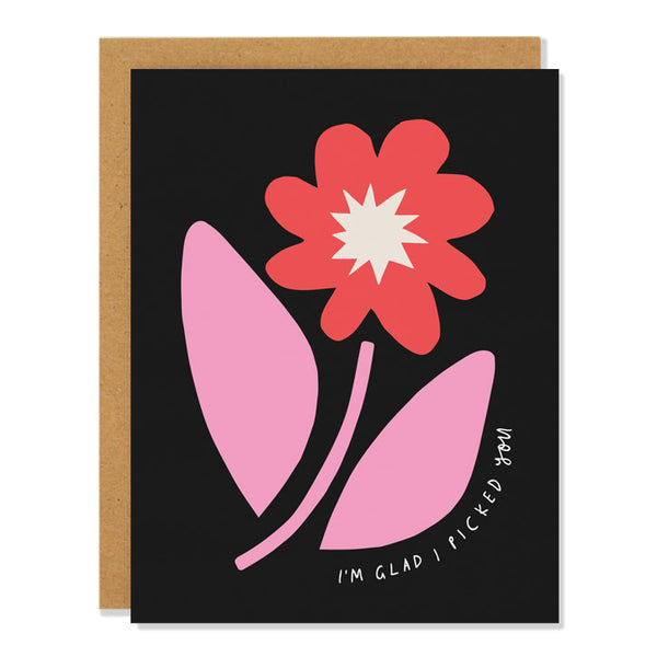 a love and valentine's greeting card featuring an cut out flower design in pink and red on a black background with text that reads "I'm glad I picked you"