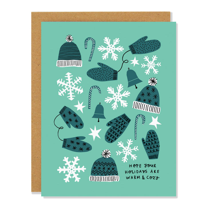 a holiday greeting card in shades of turquoise, featuring illustrations of snowflakes, mittens and gloves, toques and candy canes. Text reads: "Hope your holidays are warm & cozy"