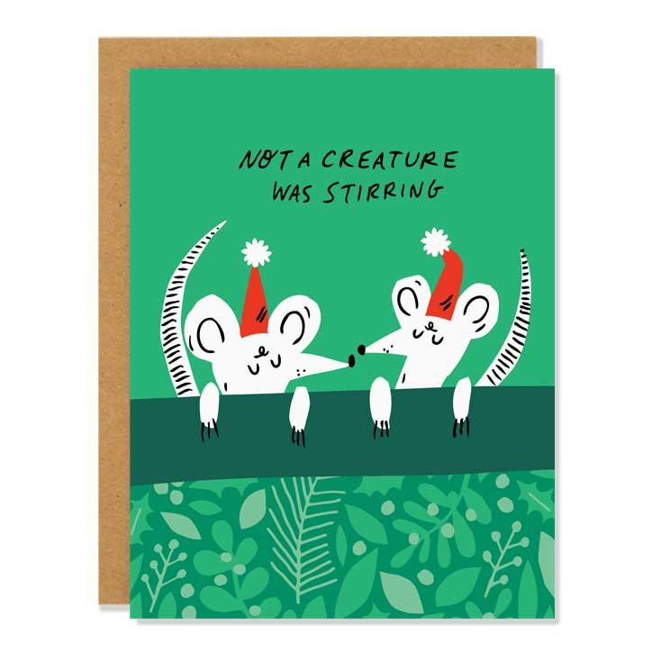 a christmas greeting card inspired by 'twas the night before christmas - featuring an illustration of two mice wearing little santa hats underneath a floral patterned blanket. Text above them reads: "not a creature was stirring".