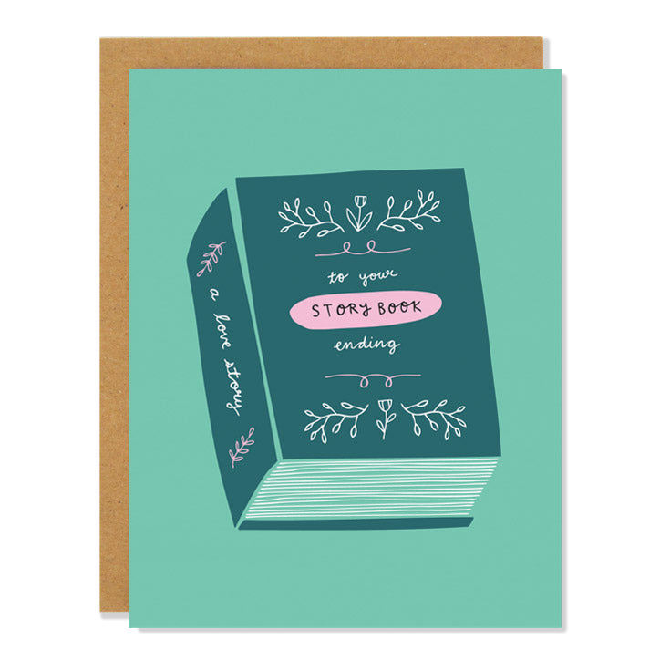 a wedding card featuring an illustration of a teal fairy tale book on a turquoise background. The handwritten text on the book reads: to your story book ending; a love story"