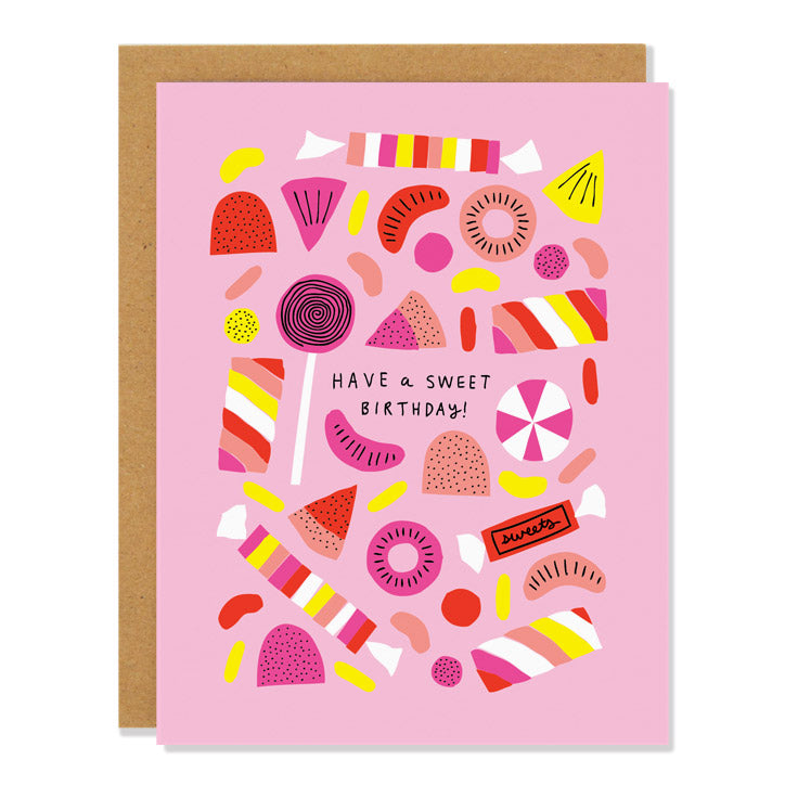 a birthday greeting card featuring illustrations of various candies and sweet treats in warm pinks and oranges on a light pink background. Text in the middle reads: "Have a sweet birthday" 